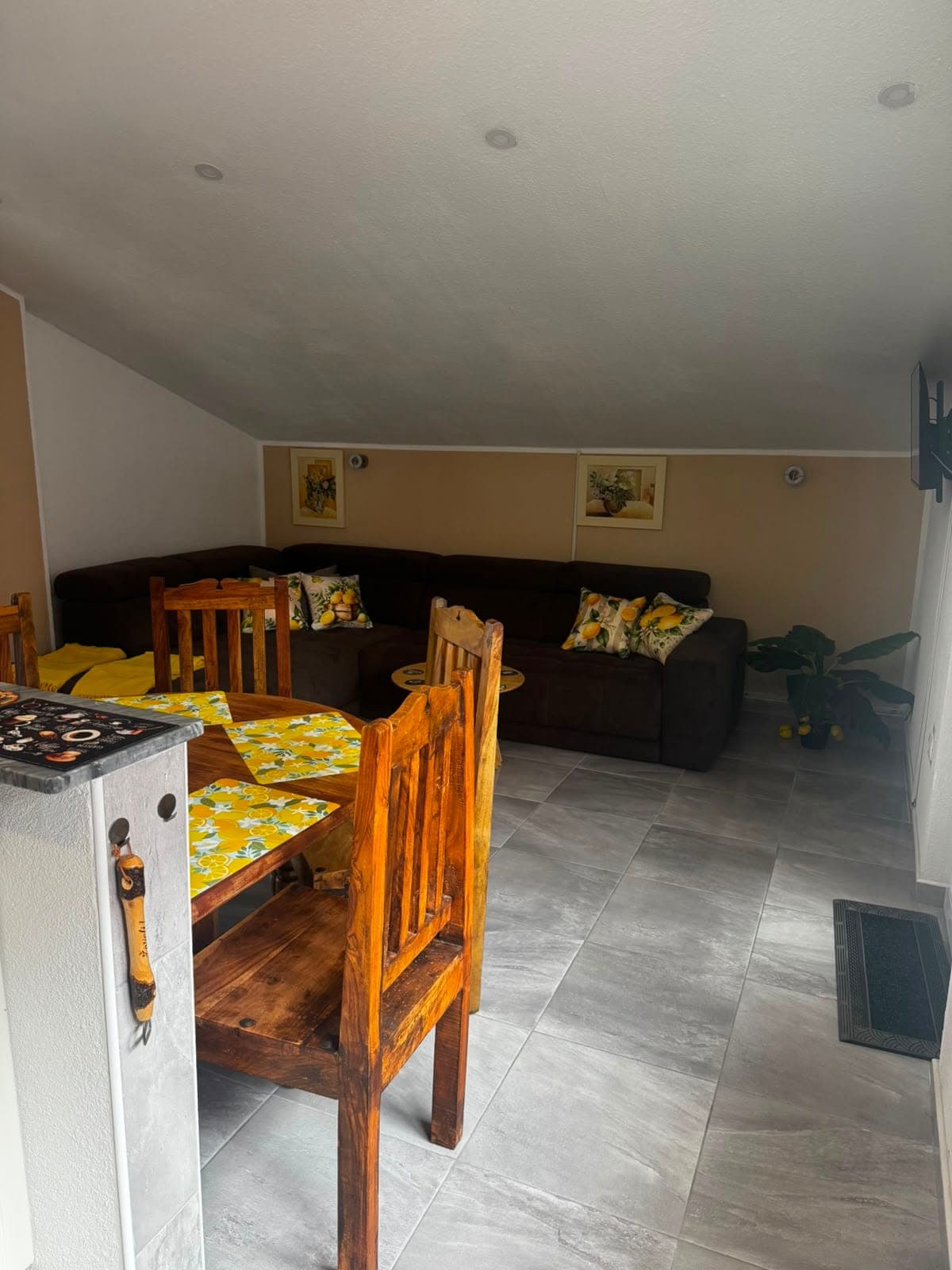Dining area with wooden table and sofa